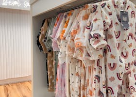 Charming display of colorful baby clothes in a modern retail store setting.